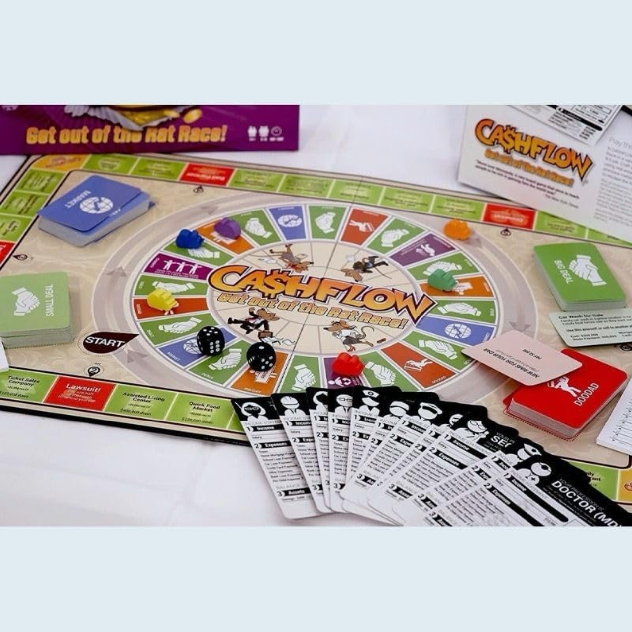 A top-down view of the Cash Flow (get out of the rat race) game board setup with play money and player tokens.