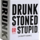 The Drunk stoned or stupid card game box and cards displayed for a party setting.